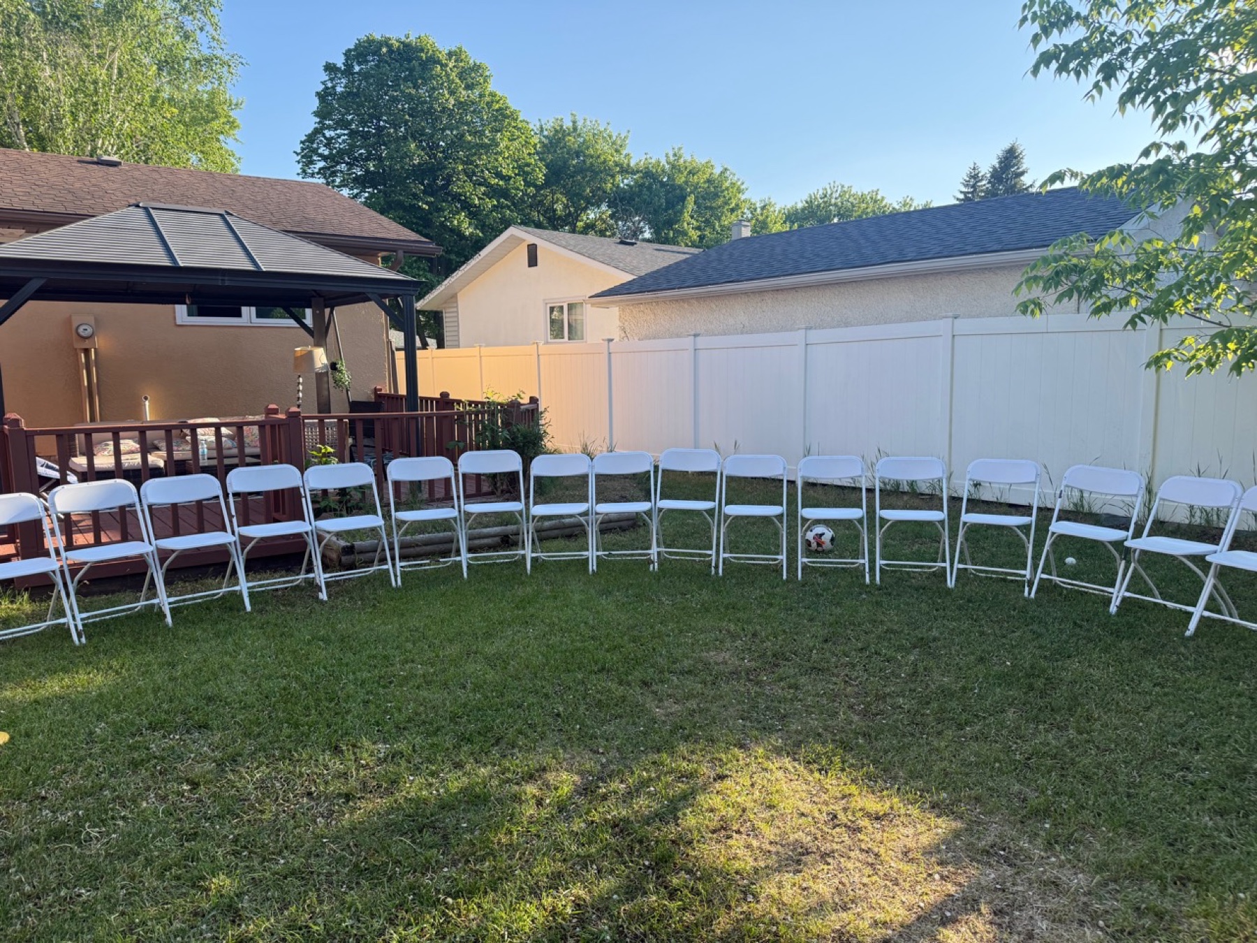 Line of white folding chairs for Winnipeg event seating