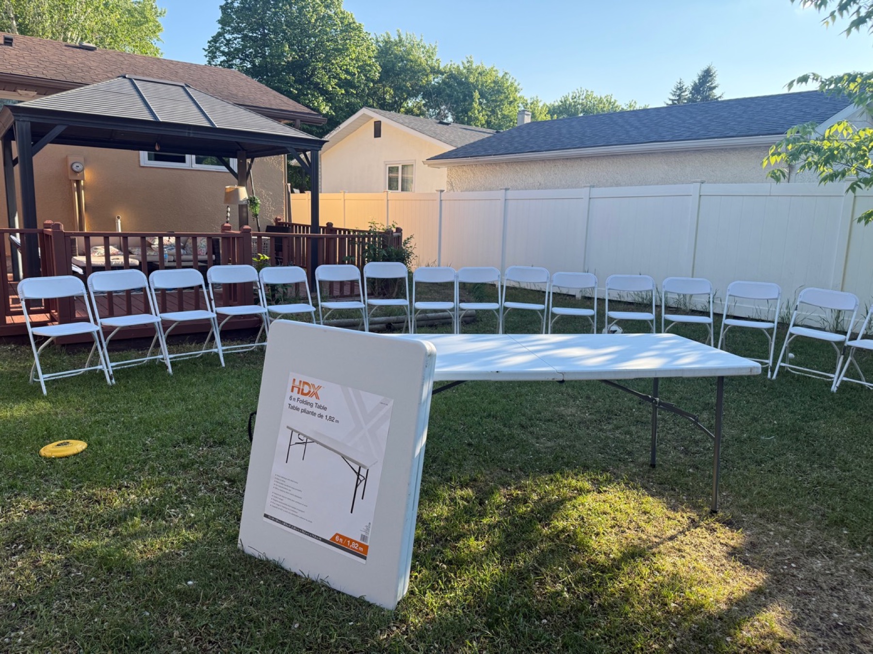 6 ft folding table with white folding chairs in Winnipeg backyard