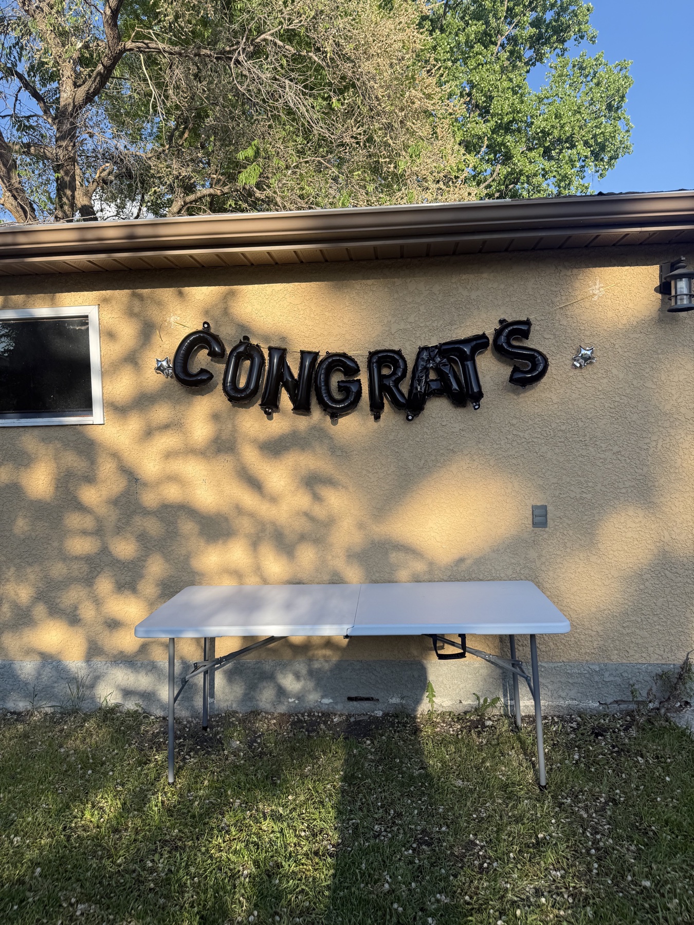 6 ft folding table under congratulations balloons for a Winnipeg event